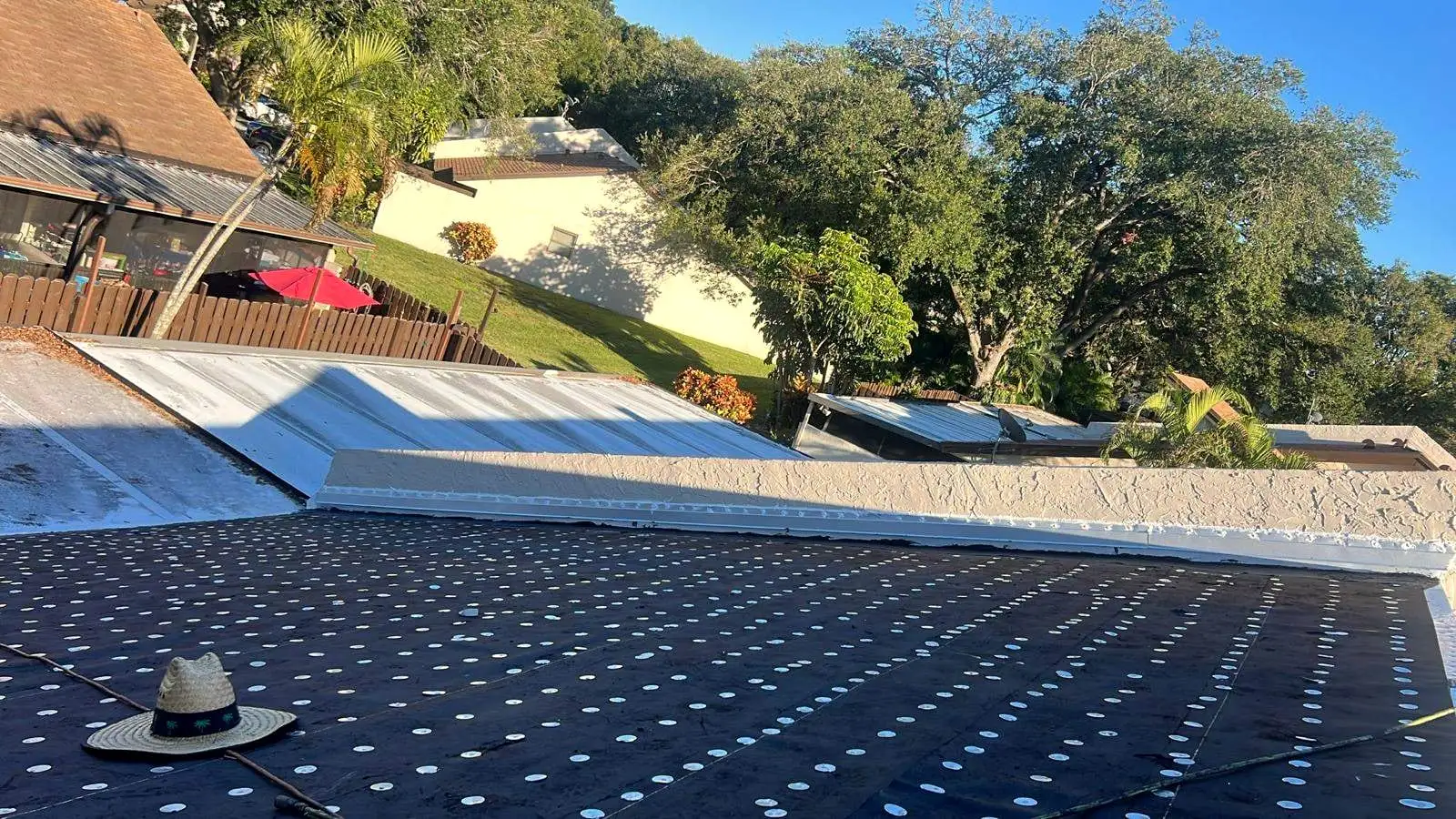 Low-slope roof dried in with cap-nailed underlayment