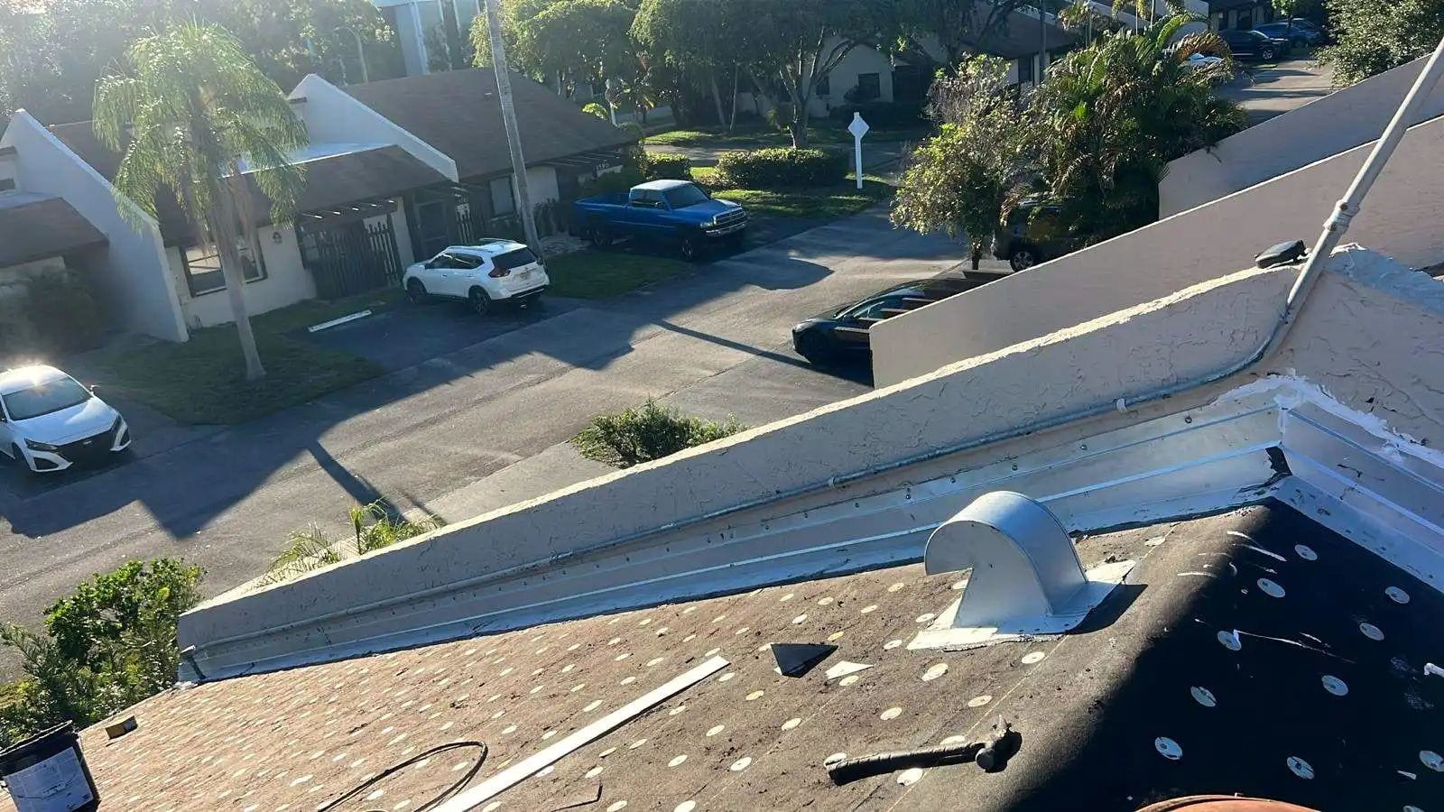 Cap-nailed underlayment and new metal flashing around a roof vent